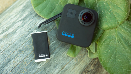 GoPro camera and battery on a leafy background