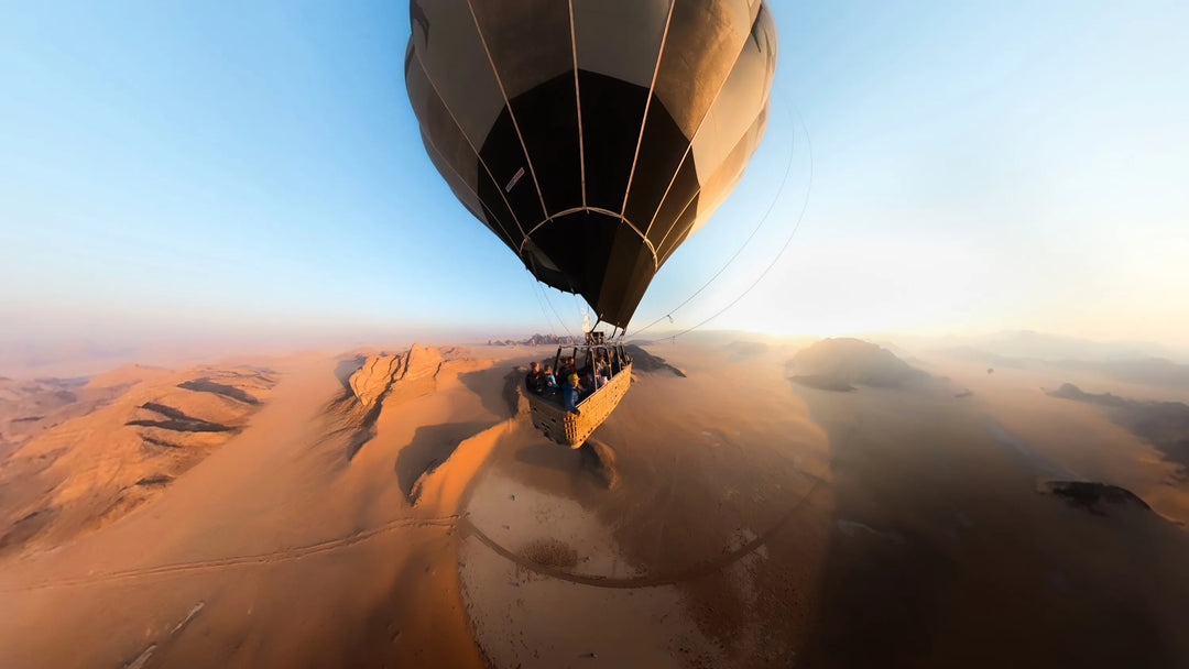 Hot air balloon over desert landscape