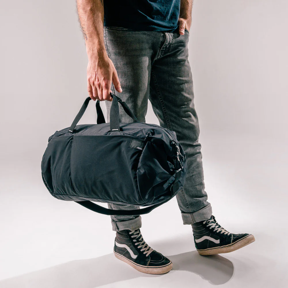 a men holding Matador ReFraction Packable Duffle bag