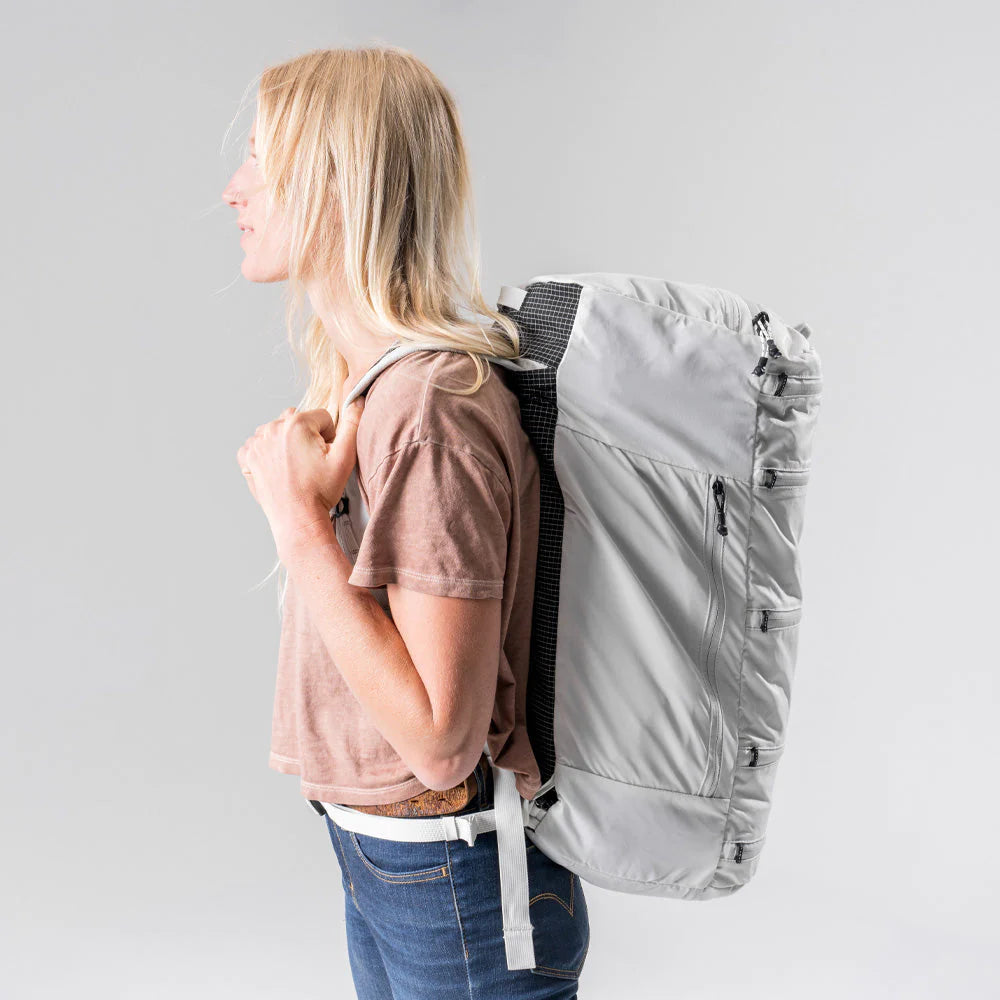 Side view of a female model with Matador SEG45 Travel Pack