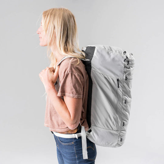 Side view of a female model with Matador SEG45 Travel Pack