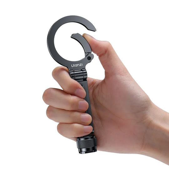 a close up shot of a hand holding Ulanzi MA07 Maglock 1/4 Cold Shoe Phone Mount M084 on a white background.