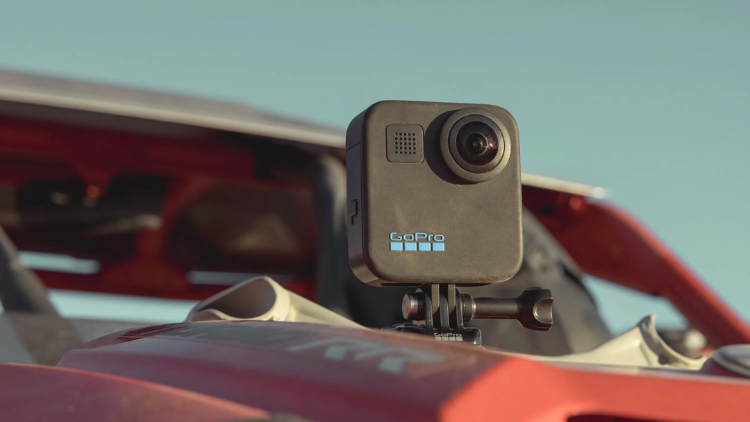 GoPro camera mounted on a red vehicle with a clear sky background