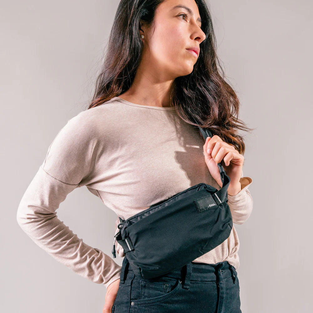 A women wearing Matador ReFraction™ Packable Sling