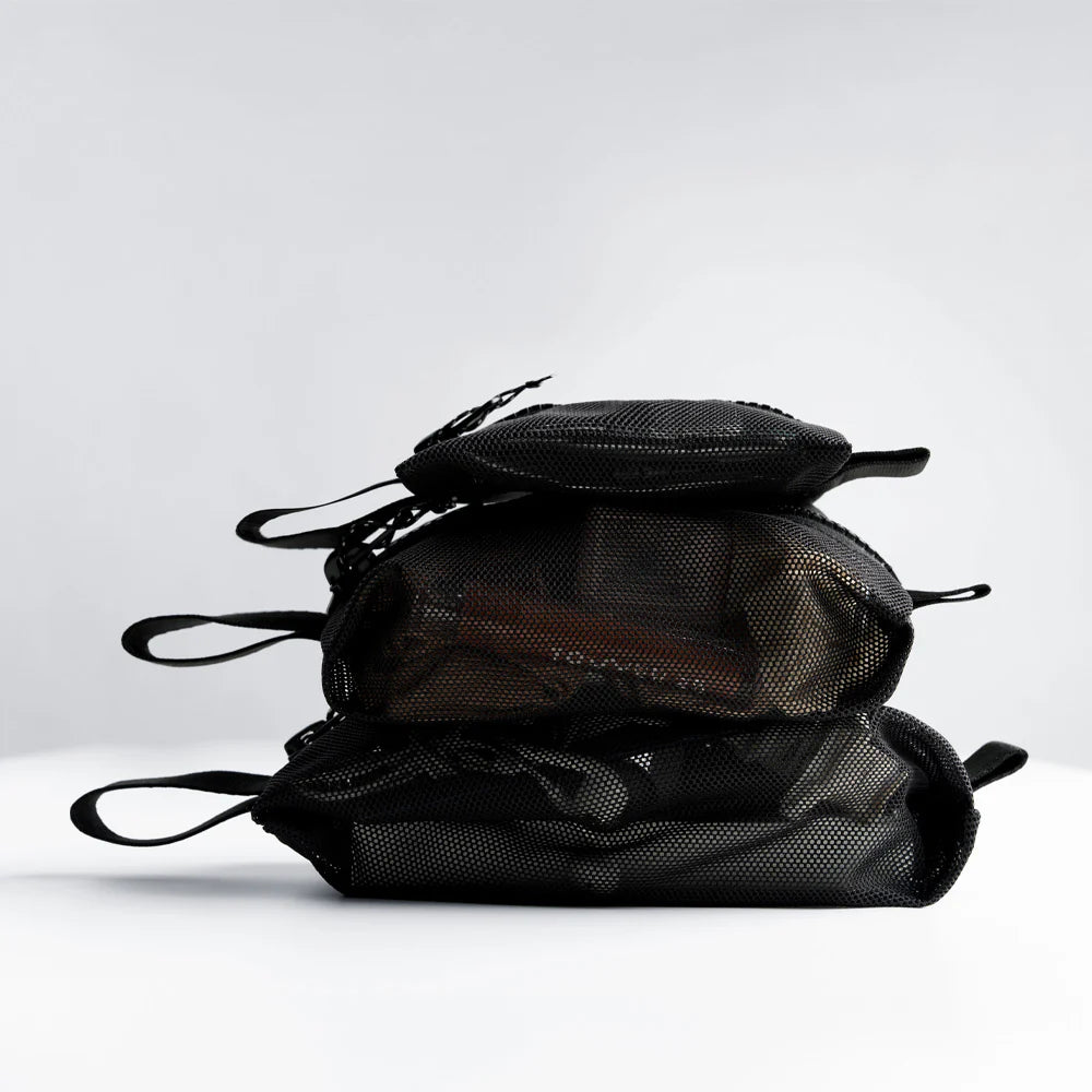 Stack of black mesh bags on a white background