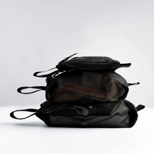Stack of black mesh bags on a white background