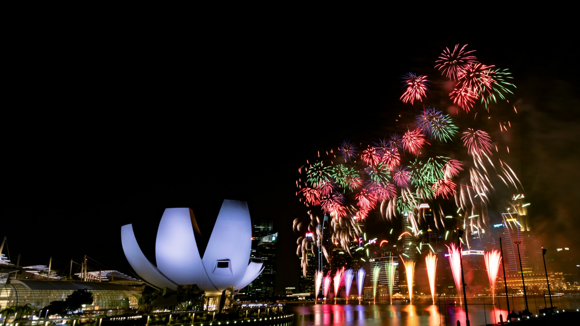 Night scence of singapore with fireworks with the text 'Celebrate National Day with Red Dot Photo'