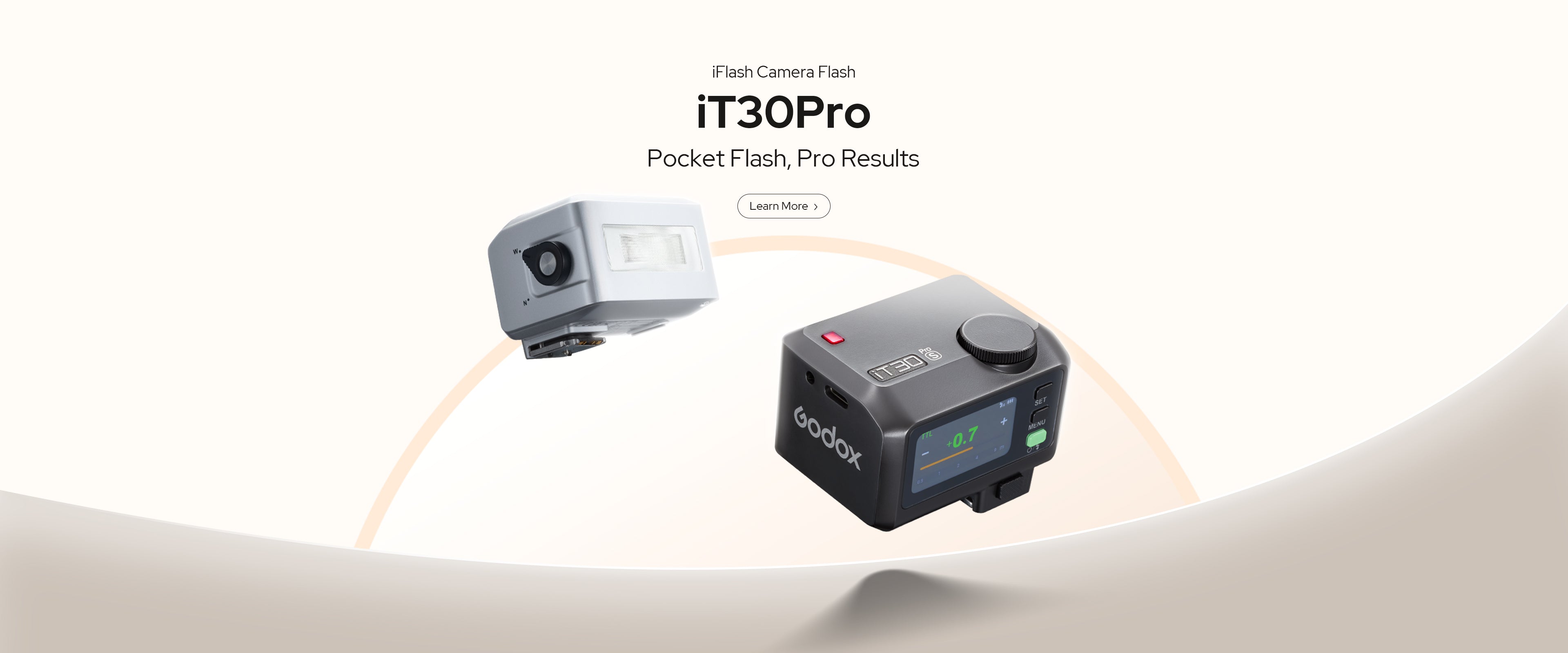 A promotional image shows two Godox iT30Pro pocket flashes, one white and one black with an illuminated screen, against a light tan and white curved background. Text reads 