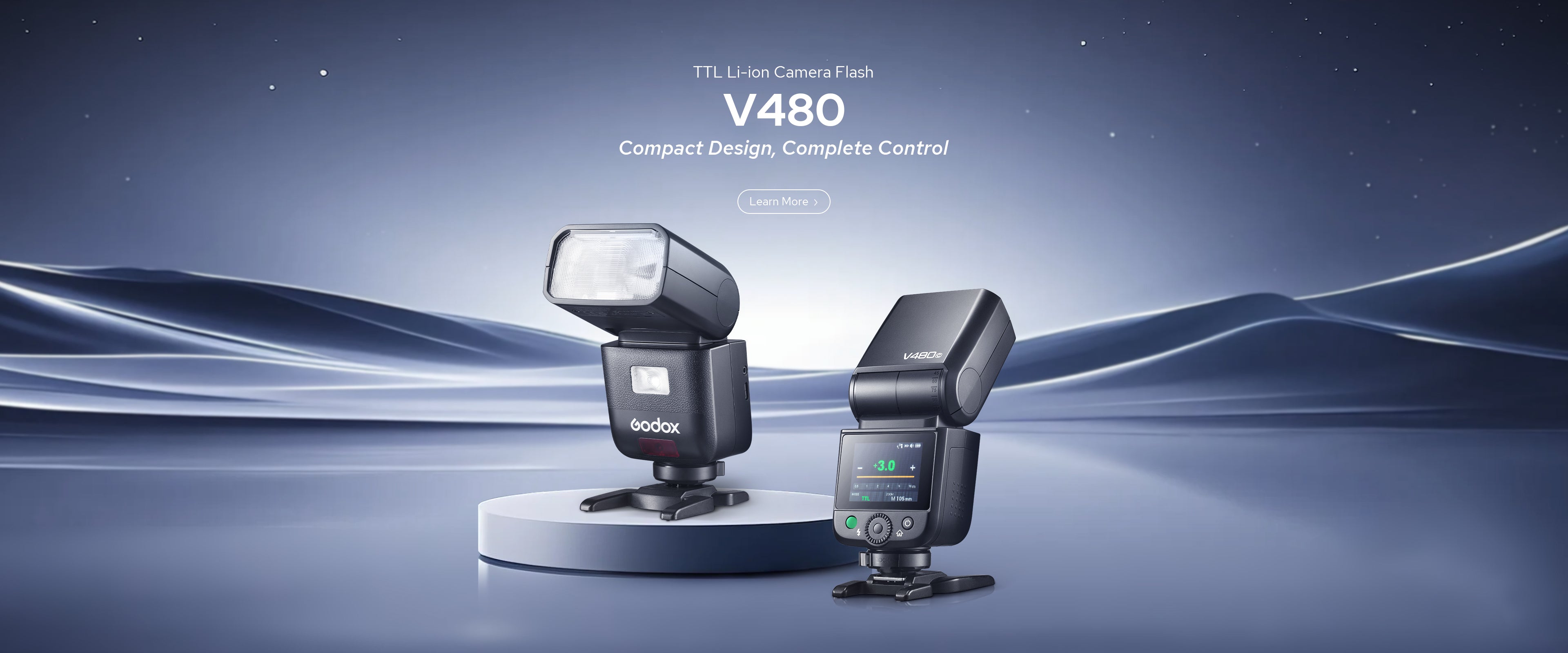 Two Godox V480 camera flashes are displayed against a dark blue, starry background with light trails. One flash rests on a white pedestal, the other on the ground with its screen illuminated. Text reads 