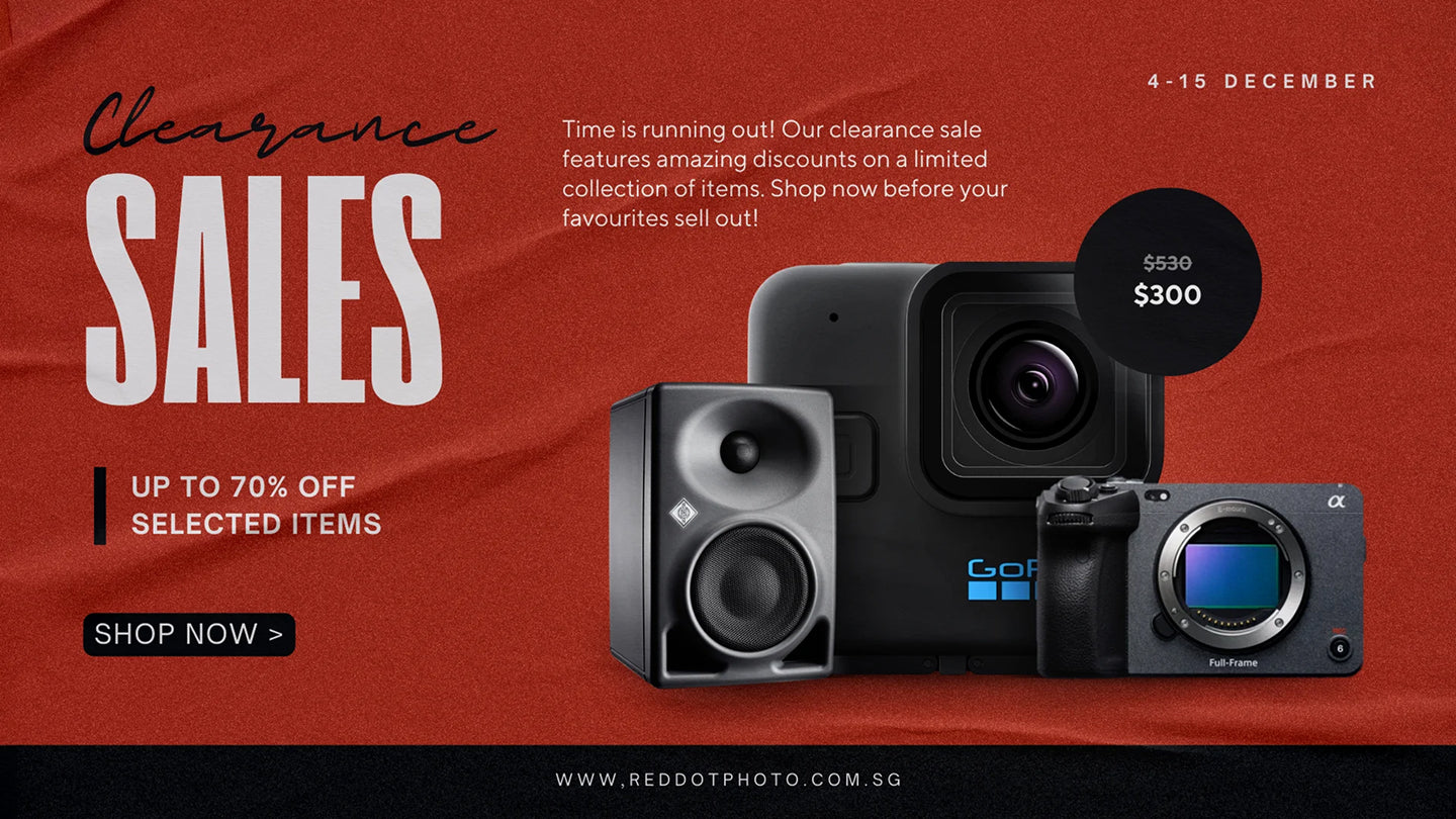 Clearance sale advertisement with camera and speaker equipment on a red background